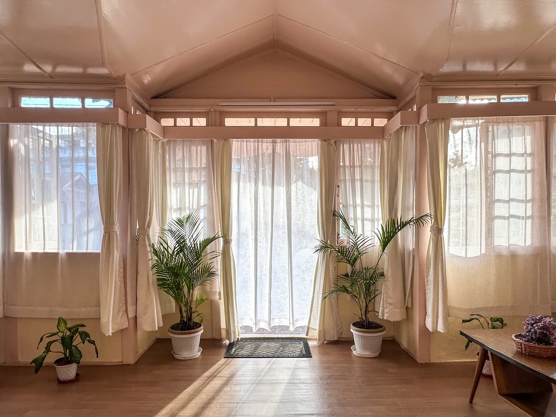 The full pink timber frontage and brick courtyard of OOtO Homestay in Shillong.