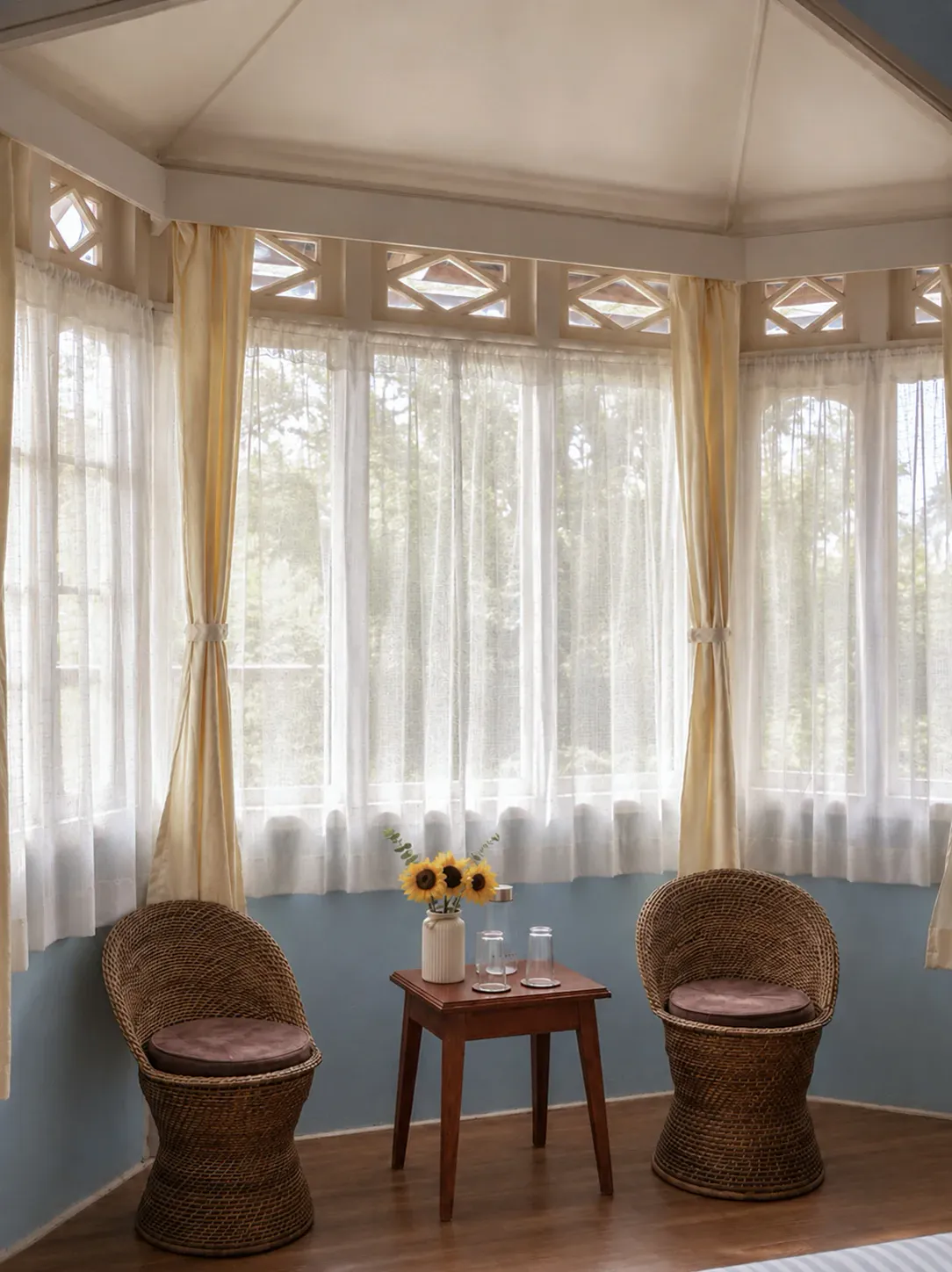 Wild Blue’s intimate bay-window seating beneath sheer curtains.